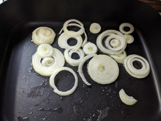 Add sliced onion to oil