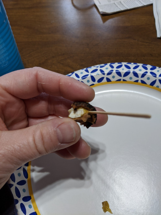 Gently poke toothpick into side of nutmeat