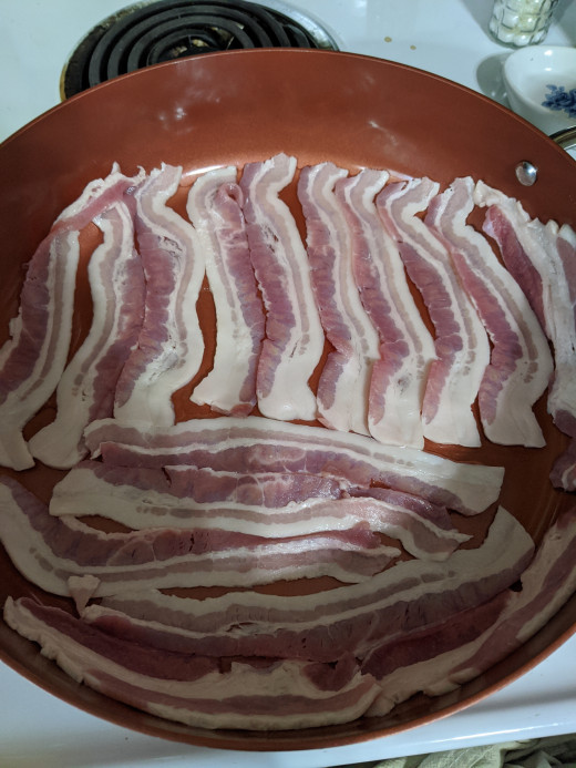 Lay cold bacon in pan, add a little water