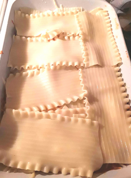 Layer noodles to create a "blanket" of pasta