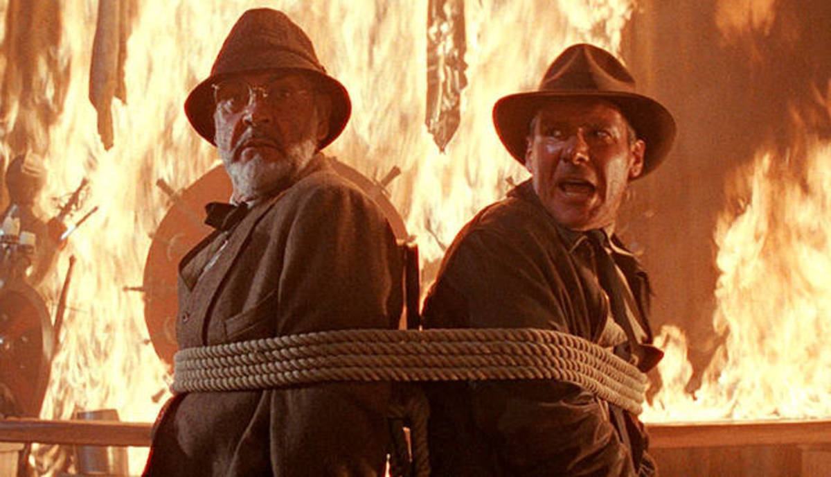 The two Jones' tied to a chair in a fire room.