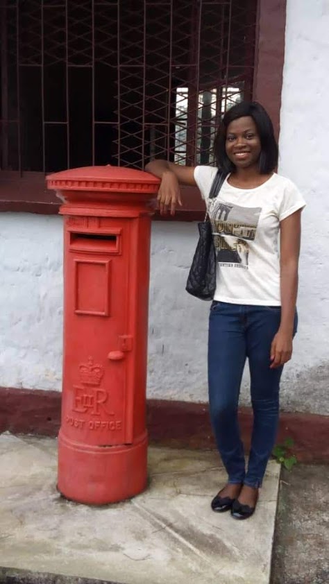 Posing before one of the oldest post offices in Cameroon