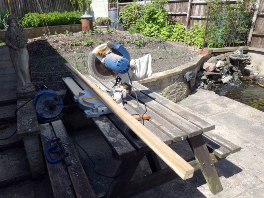 Using a mitre saw to cut the timber to lengths for making the front panel frame. 