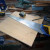 Using the back of a handsaw as a square to mark out the wood, to cut the middle shelves to size.