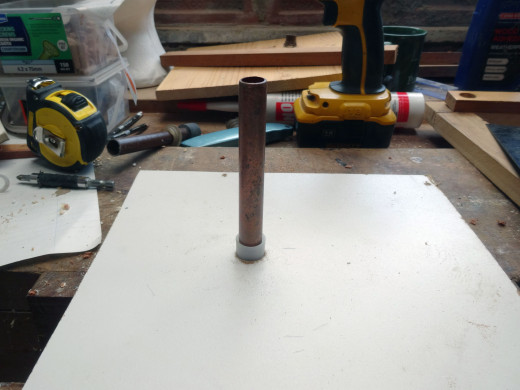 Copper pipe test fitted, held firmly in place with a spare plastic plumbing cap end.