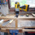 Drilling the holes for dowel jointing the new middle rail in place.