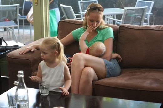 Most women nowadays do not feel shy to breast feed in public but it is up to you and what is your priority, baby or your shyness. Try to find a private place is you are so shy of it.