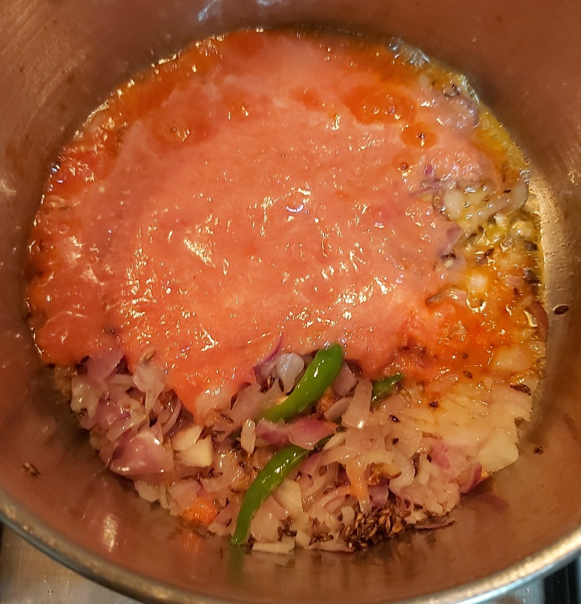 Pour ground tomato paste to this onion mixture.