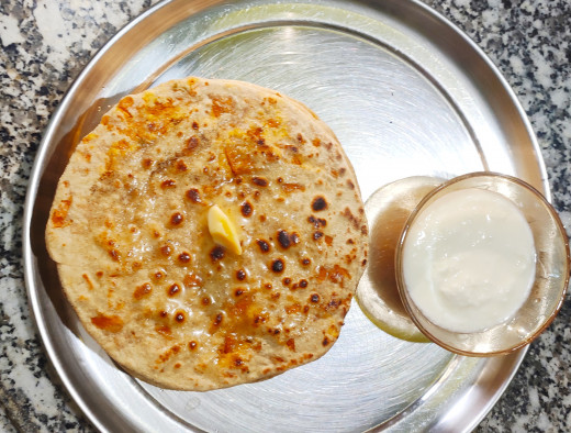 Delicious Gajar-Chhena paratha served with butter and curd
