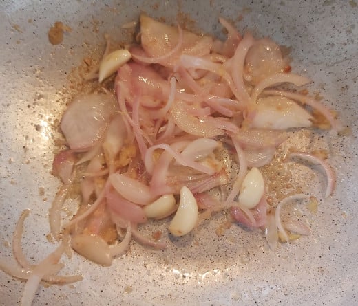 Fry till onions turns golden brown and raw smell of ginger and garlic goes away.