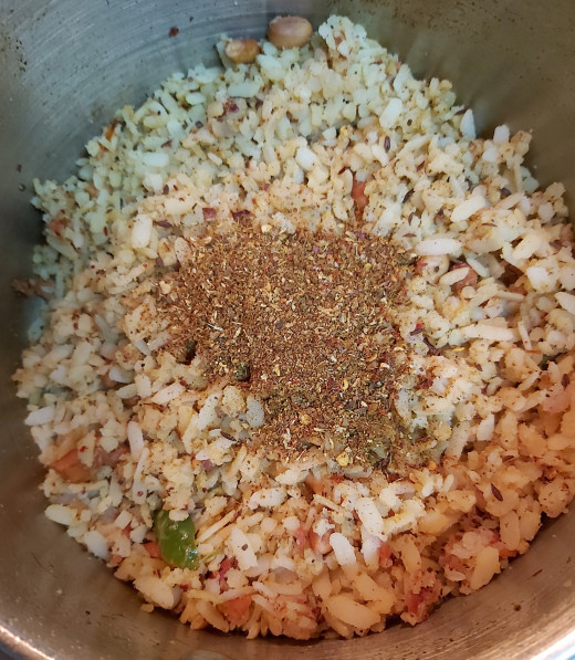 Mix gently without breaking poha. Add more spice powder and salt if required. Keep the flame low.