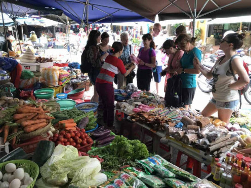 People at a market haggling at vendors