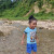 Child playing in Small River