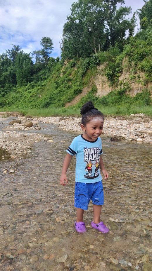 Child playing in Small River