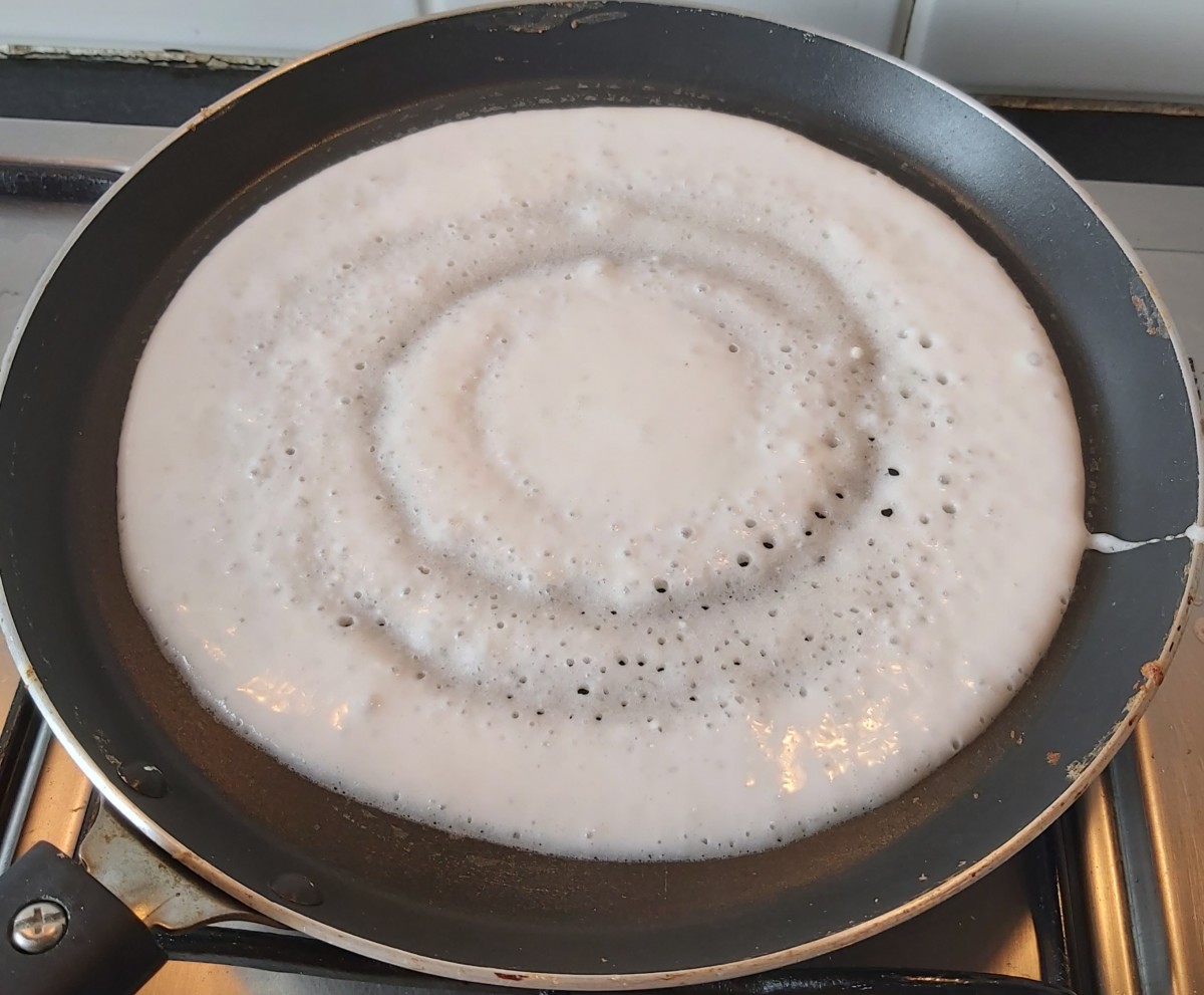 Heat tawa on medium flame. Add ladleful of batter on hot tawa and gently spread in circular motion. Sprinkle some drops of ghee or oil on dosa (optional).