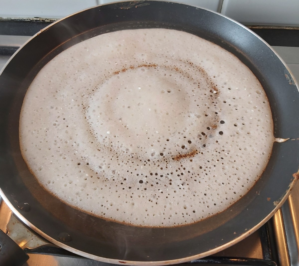 Cook till dosa cooked completely (you can see the base turned brown). You can roast it too. No need to cook on other side. Lot of holes on dosa indicates batter fermented well (well fermented batter gives porous and soft dosa).
