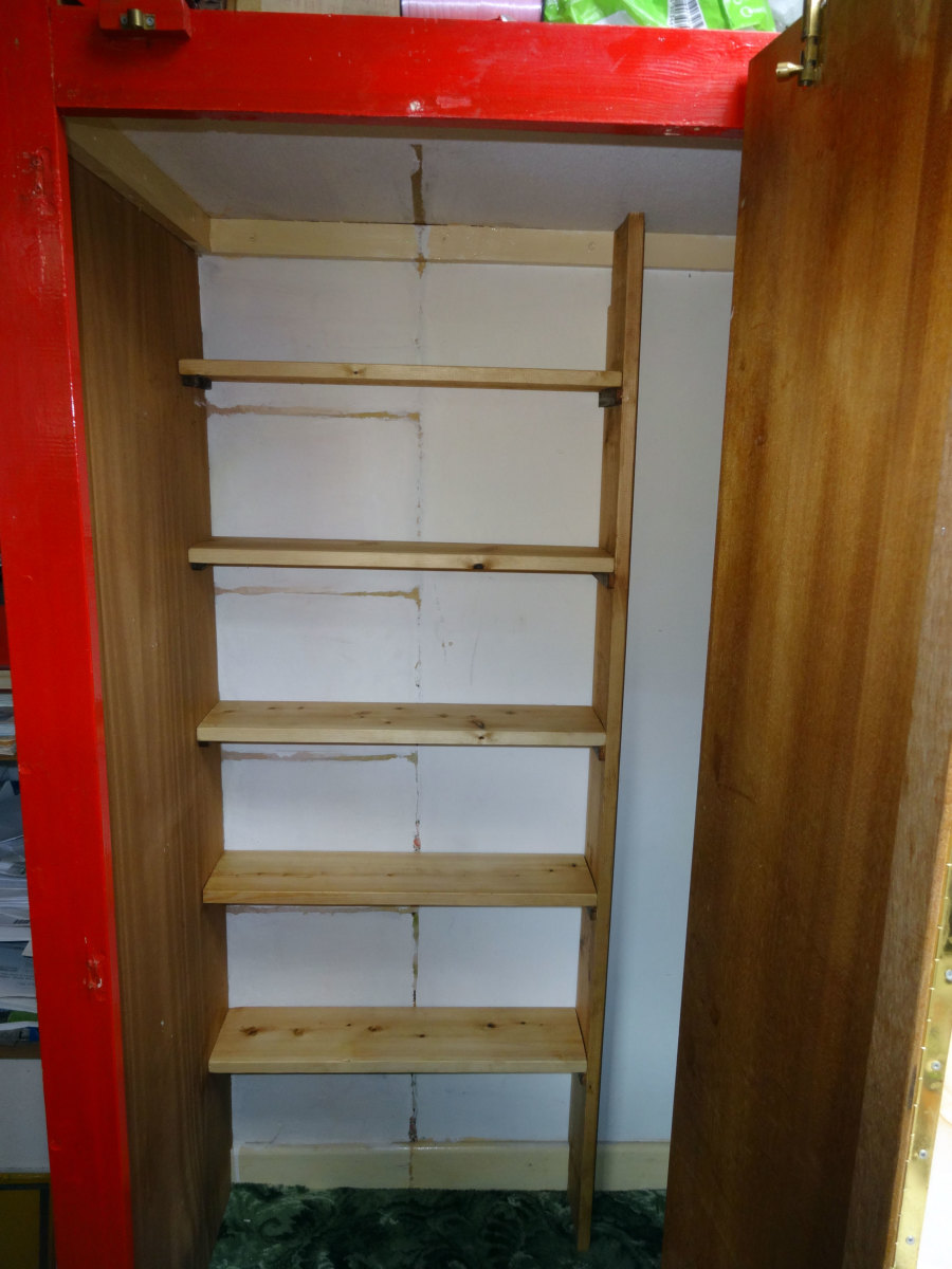 The new book case, made from pine floorboards (6 inches depth), in a more accessible location. On the back wall, the outline of the original pigeonhole shelves, that were previously removed because they were too deep 