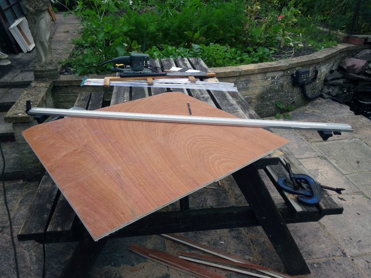 Cutting the plywood to size and shape to make the folding doors