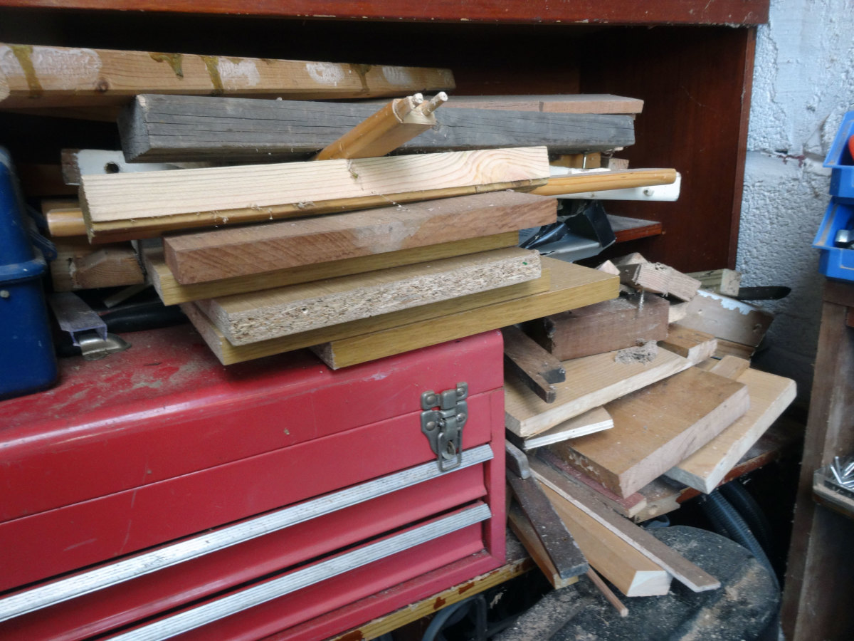 Pile of scrap wood to choose from for fitting the speakers into the wardrobe.