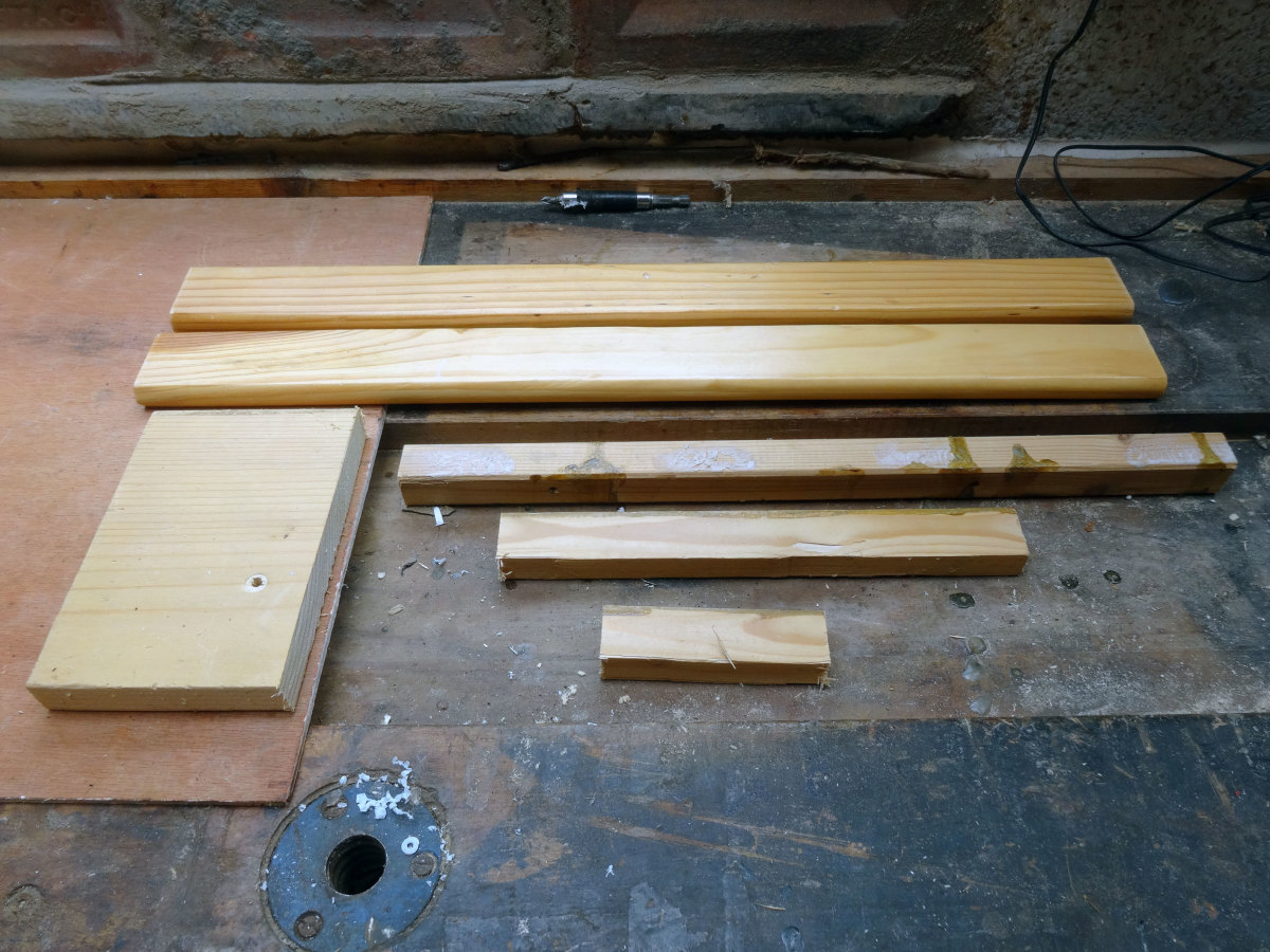 The pieces of scrap wood selected to use for fitting the speakers into the wardrobe.