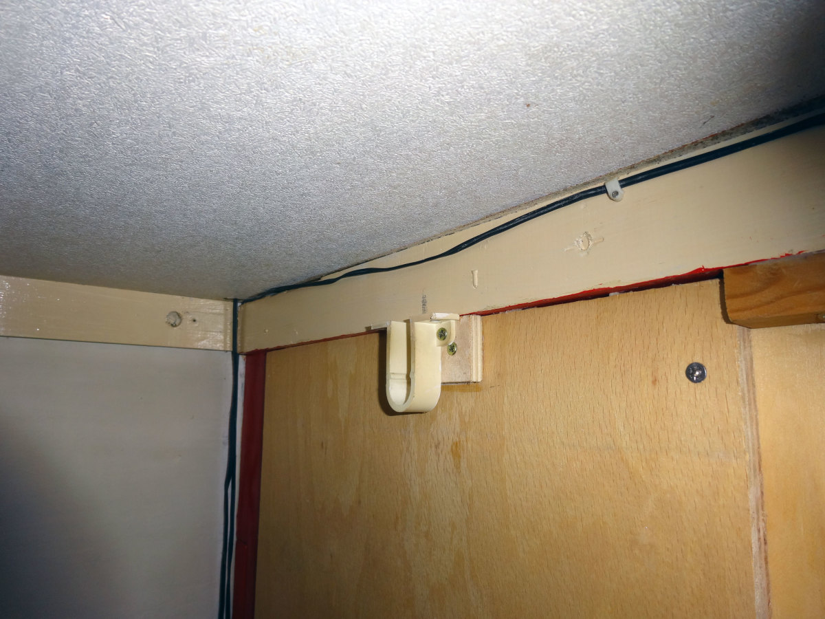 The front clothes rail bracket screwed into position.