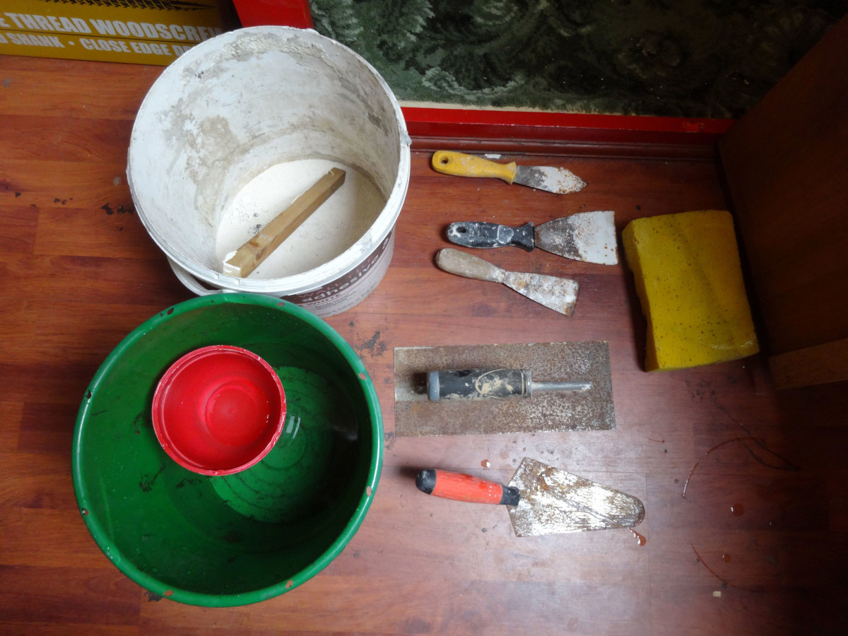Plaster bucket and all plastering tools laid out ready for use.