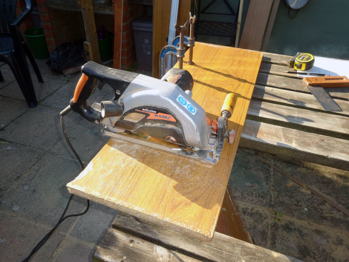 Using a circular saw to the cut the shelving to length.