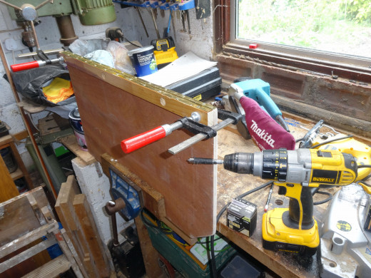 Clamping the hinge jamb and door panel together, to screw the piano hinge to the hinge jamb; ensuring it opens outwards.