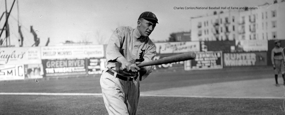Cobb swinging for a photograph. 
