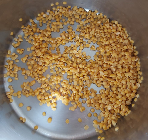 In a bowl or vessel, take 1/2 cup of split pigeon pea lentils or toor dal. Wash thoroughly in water for 2-3 times.