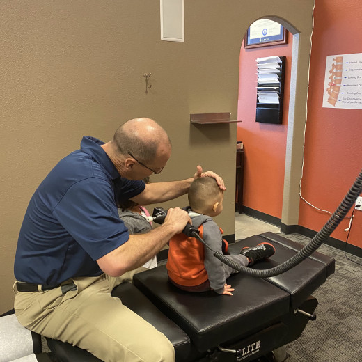 Dr. Kinnison checking a child at Express Chiropractic in Fort Worth Texas