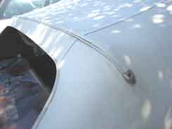 Top molding that is removed to expose staples into the rear top bow.