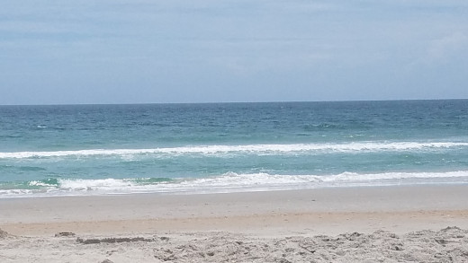 Wrightsville Beach has beautiful sand and colorful water on a sunny day.