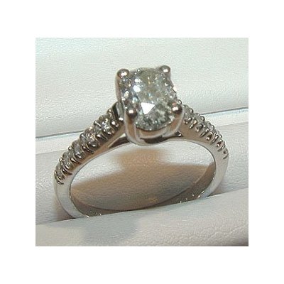 Modern solitaire engagement ring with extra diamonds on the band