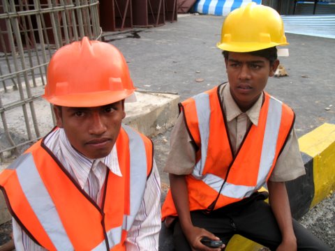 These boys in heavy construction Govt work wearing Helmets with out ISI mark a punishable offence but no asker.