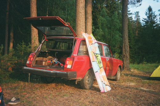 A red vintage three-door hatchback is parked in the woods. Hatchbacks were cool then, and they're still darn good now.