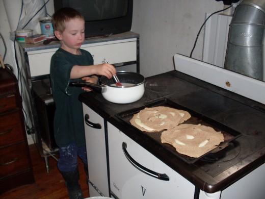 My son, six, preparing soup to go with our quesadillas. (We're using a wood-or-coal cookstove.)