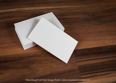 "Piles of blank business cards on wood table background. Blank stationery." by www.readyelements.com is marked with CC0 1.0.