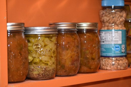 Keep glass jars of home canned foods close to the bottom shelf where they can't be easily broken. Large quantities of canned items need reinforced wooden shelves, where possible. 