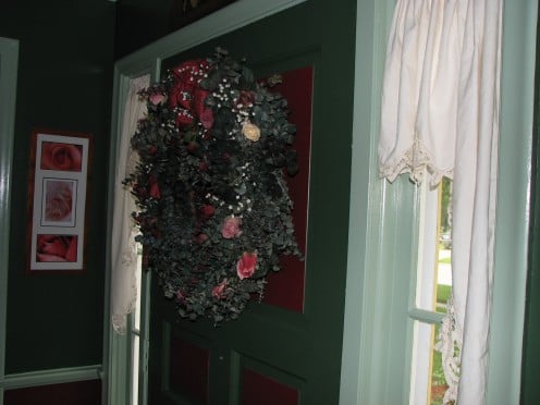 The front door; adorned with eucalyptus wreath and real dried roses. 