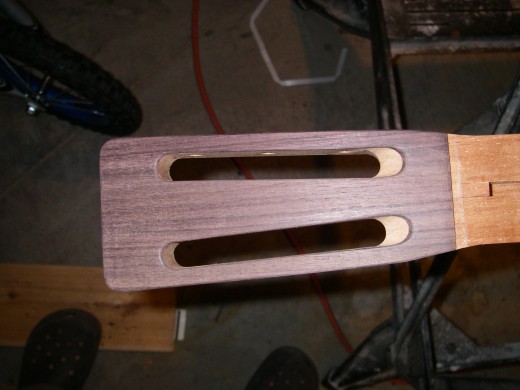 Rosewood added to headstock, fitted, and angle filed for strings.