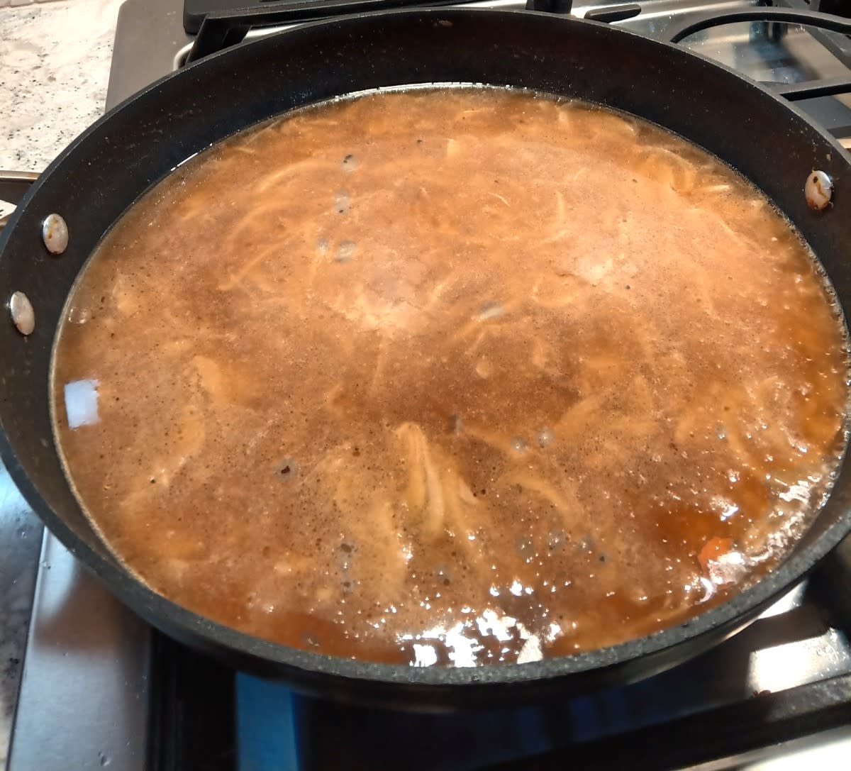 Beef broth added to the pan
