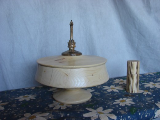 Ten-inch by ten-inch lidded pedestal box turned entirely from construction cutoffs scavenged from a worksite.