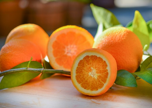 a group of oranges sitting on top of a wooden table, photo by Cristina Anne Costello on Unsplash