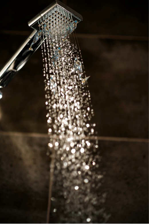 A close up of a shower head with water coming out of it, photo by Ginger Hendee on Unsplash