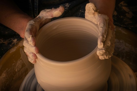 Person Holding White Clay Pot, photo by Earl Wilcox on Unsplash