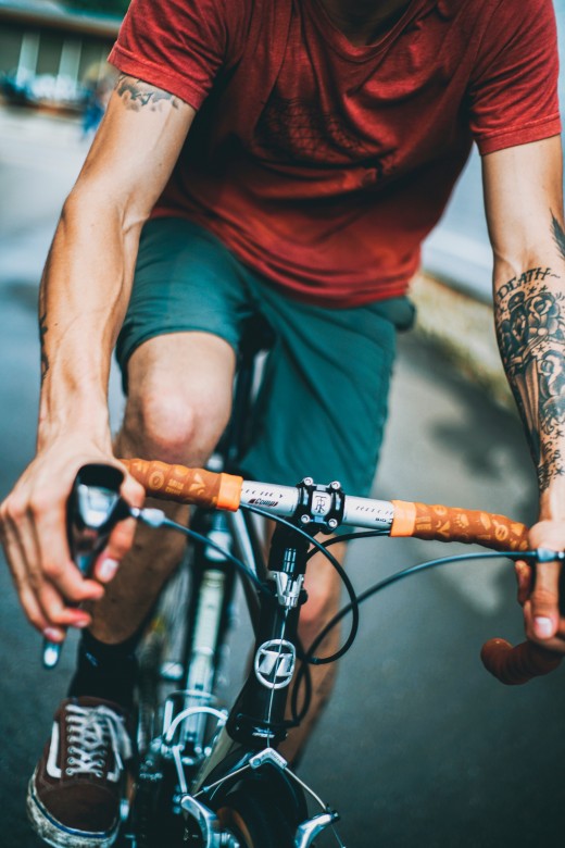 Man riding black and gray bicycle, photo by Dan Russo on Unsplash