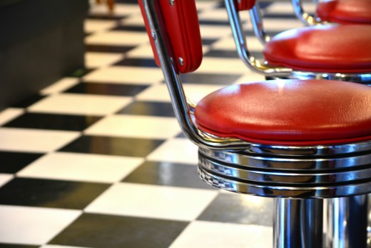 Red padded bar chairs in Tampa, FL, photo by R. Mac Wheeler on Unsplash
