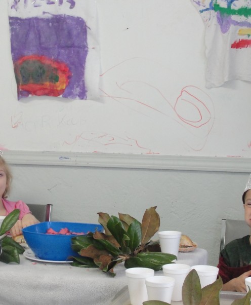 Adding the "tapestries to the wall that the children painted in a previous lesson
