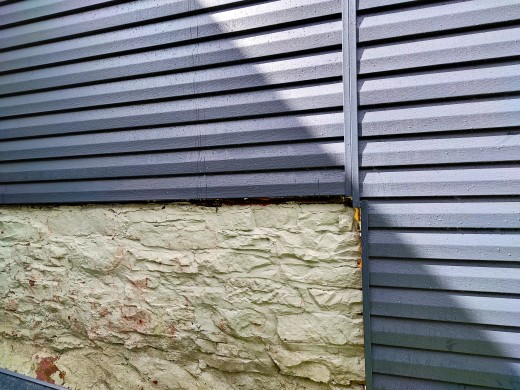 The pressure washer did a great job of washing the siding and painted stone foundation